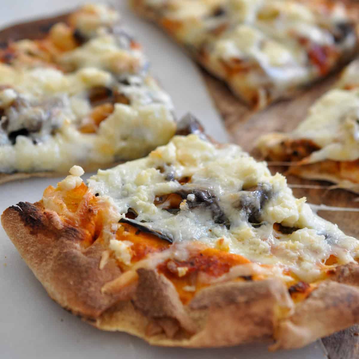 Pita pizza with mushrooms and feta cheese.