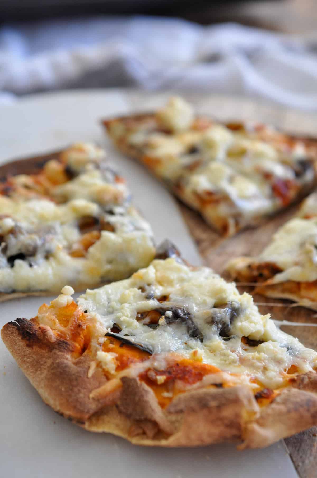 Pita pizza with mushrooms and feta cheese.