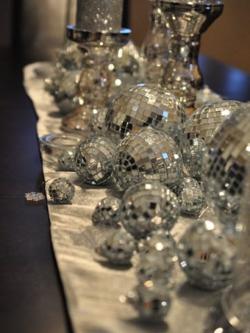 New Years Party Decor: candles, clocks, noise makers, party hats, and mirrored balls create the perfect party atmosphere for New Year's Eve!