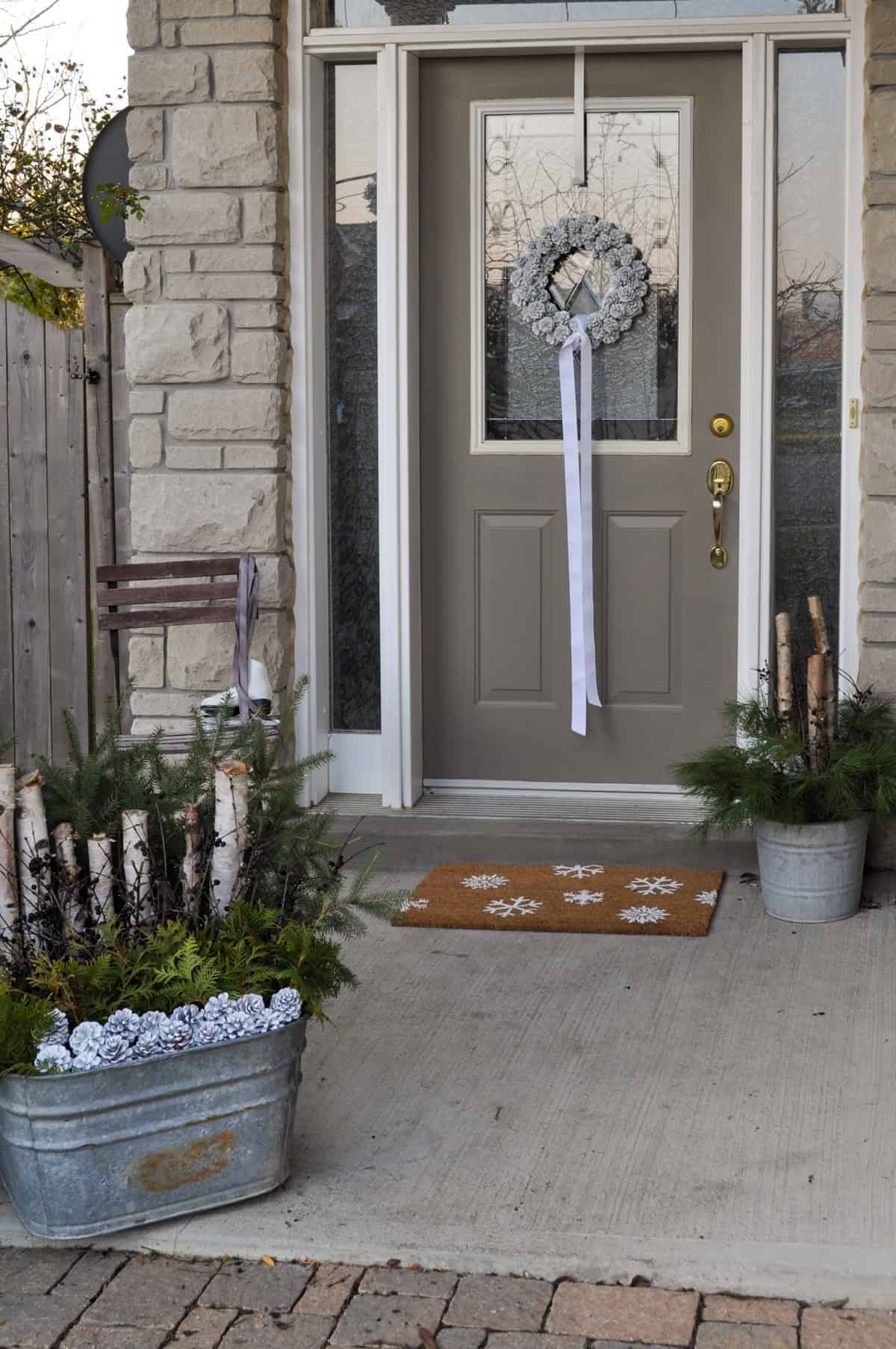 Christmas front porch decor urn, door mat, wreath.