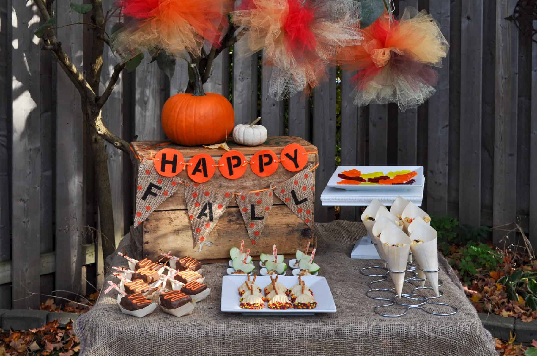 Leaf raking fall themed party ideas and fall dessert table.