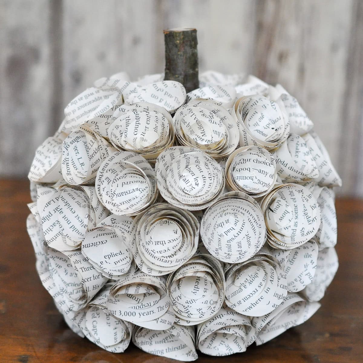 Book page paper flower covered pumpkin.