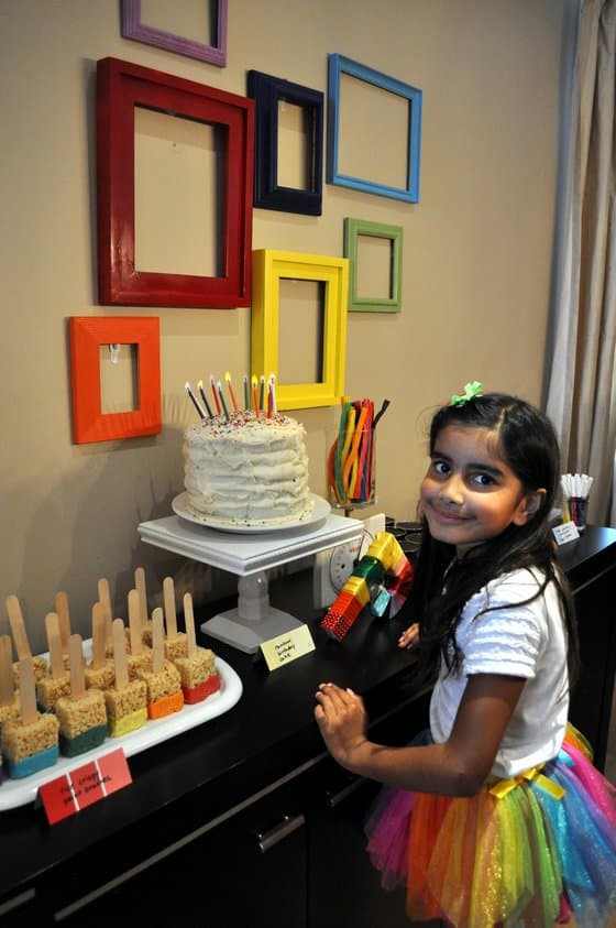 birthday girl at dessert table.