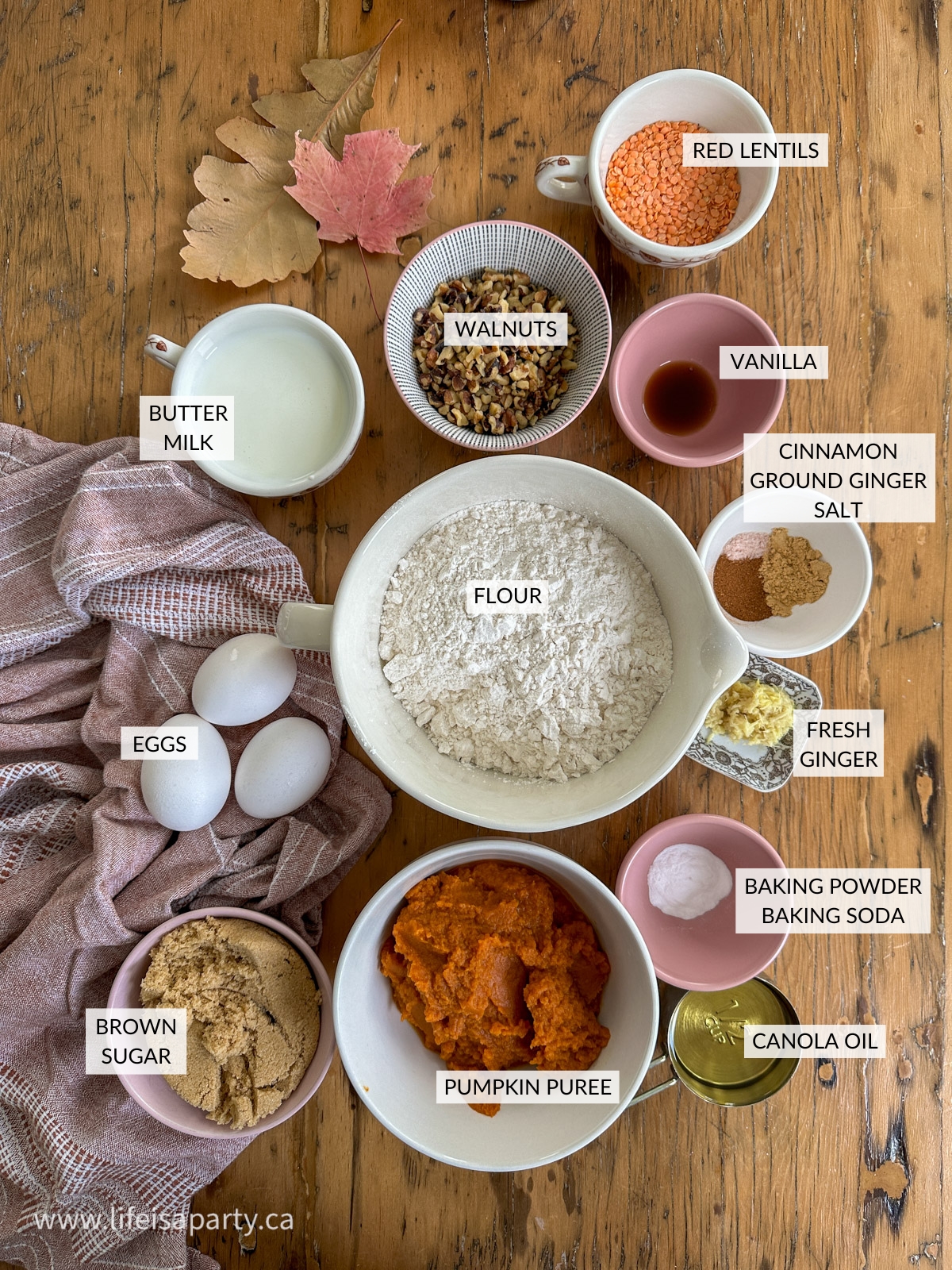 Ginger pumpkin loaf with walnuts ingredients on a table in small bowls.