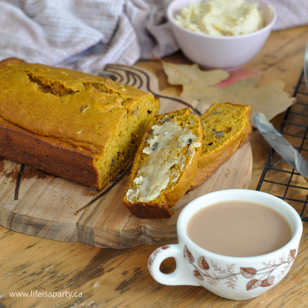 Pumpkin loaf with walnuts on a cutting board.