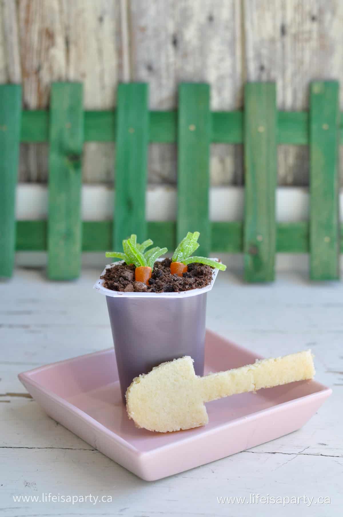 Dirt pudding with carrot candy and sugar cookie spoon.