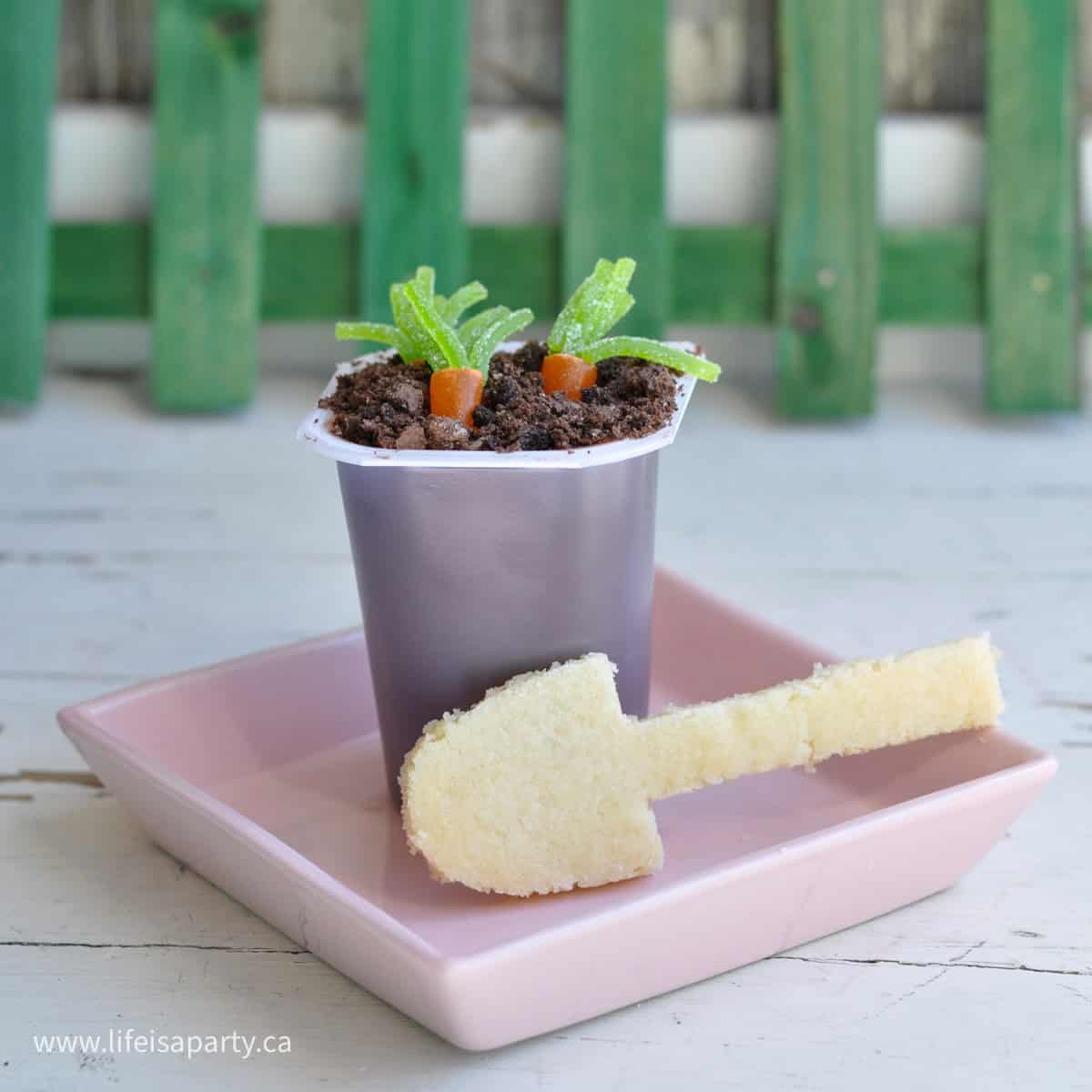 Dirt pudding with carrot candy and sugar cookie spoon.