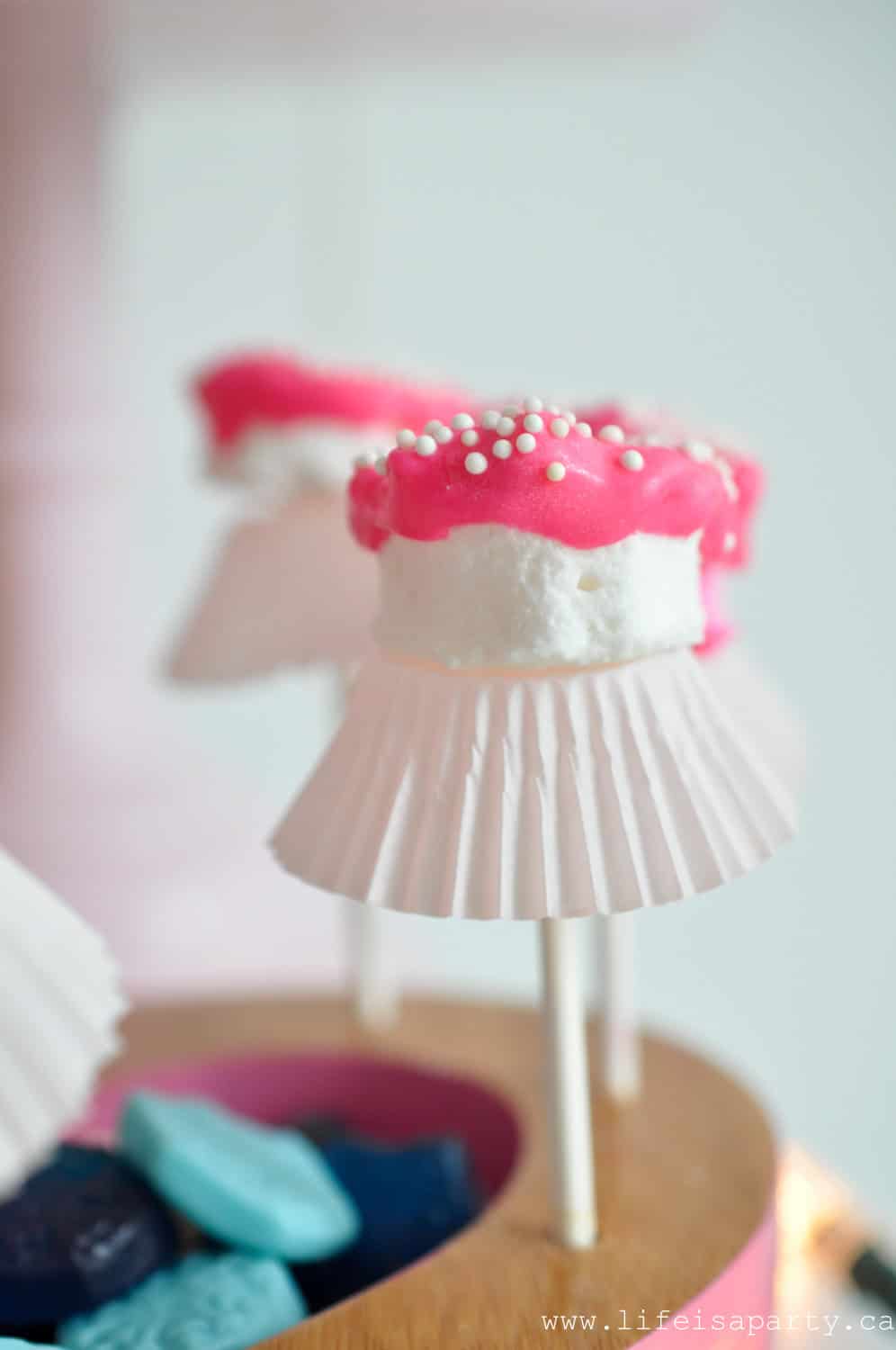 Nutcracker themed food ideas marshmallow ballerinas with cupcake paper tutus.